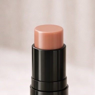 Cosmetic stick with a pinkish-beige color 